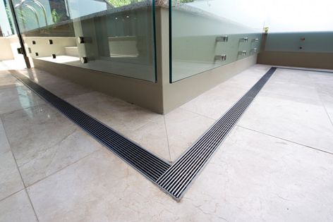 A slimline Stormtech grate used as a shower drain. 